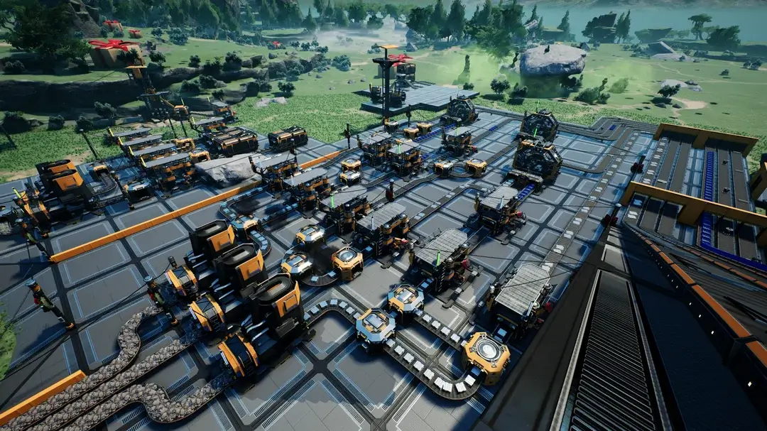 Satisfactory early-game factory on foundations with belts, constructors, and storage